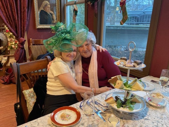 Two women enjoying a holiday tea.