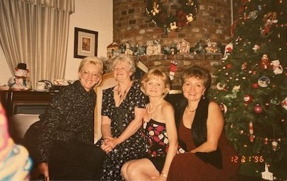 Pam and three friends at a holiday party
